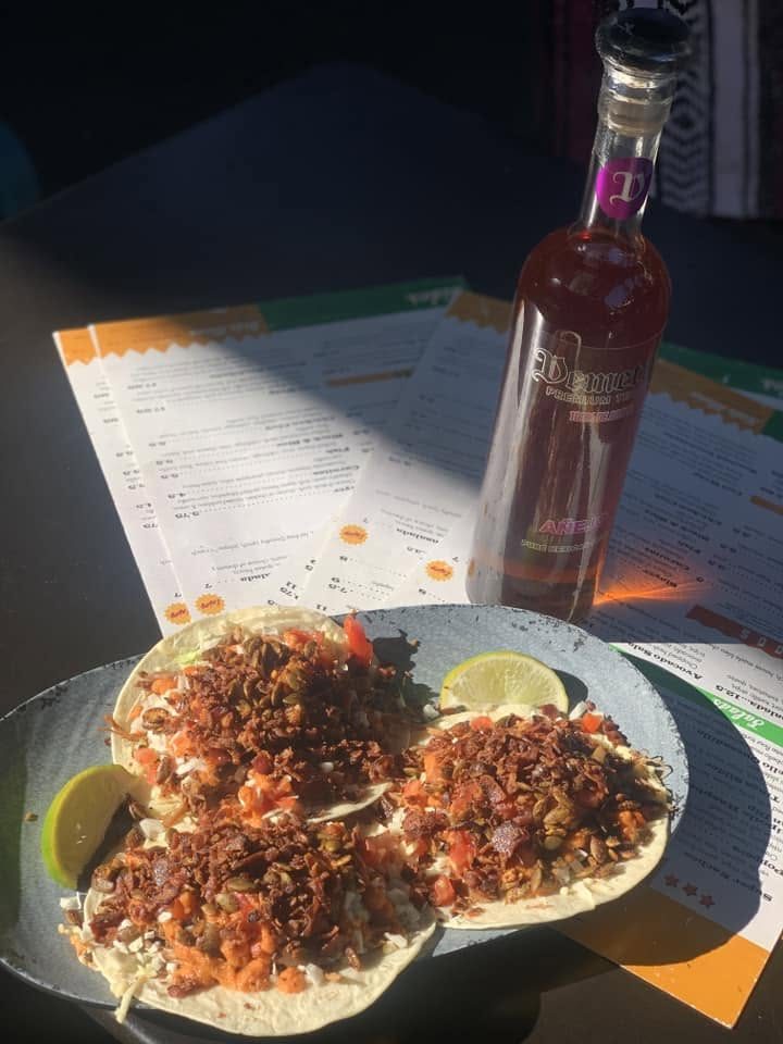 Tacos and a bottle on the table
